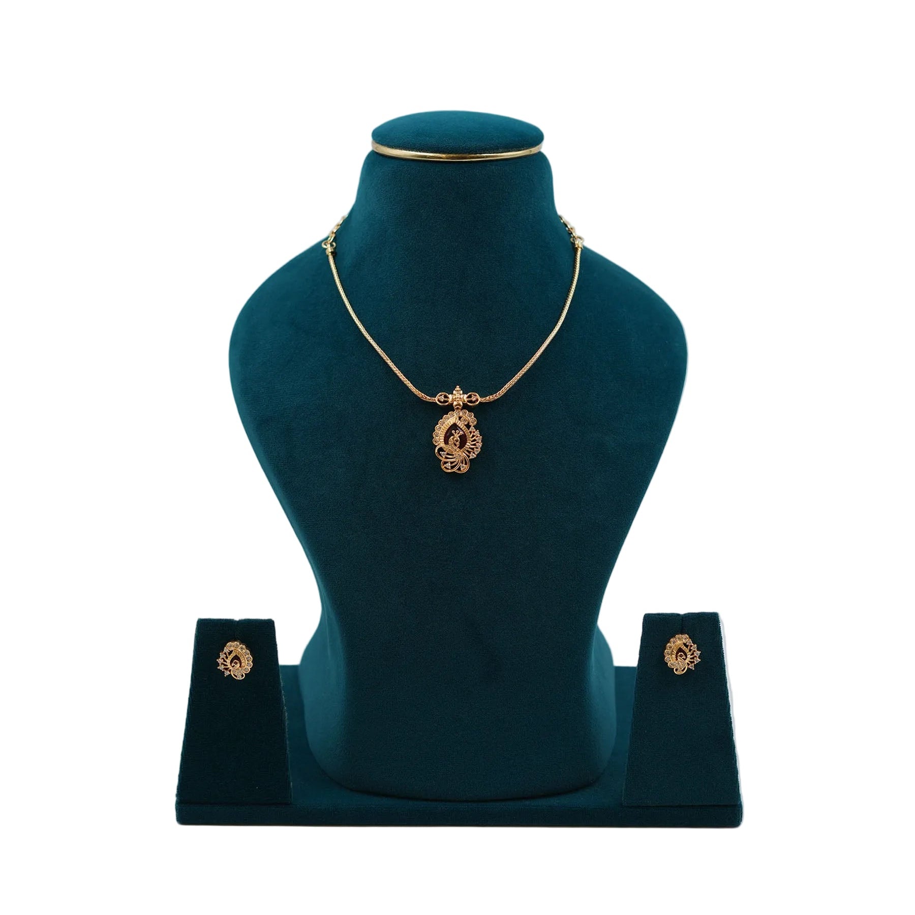 Lalithambike 1-gram gold pendant set featuring a modern filigree design with a ruby-toned center stone and matching stud earrings on a teal jewelry bust.
