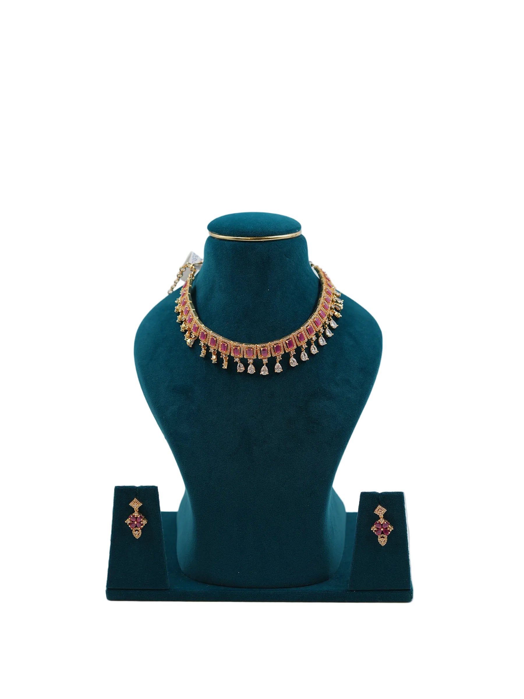 Lalithambike 1-gram gold choker featuring a row of ruby-toned stones and dangling teardrop gold accents, with matching floral earrings on a teal display.