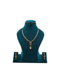 Lalithambike 1-gram gold star-motif necklace featuring a large crystal teardrop pendant and matching long-drop earrings on a teal display.