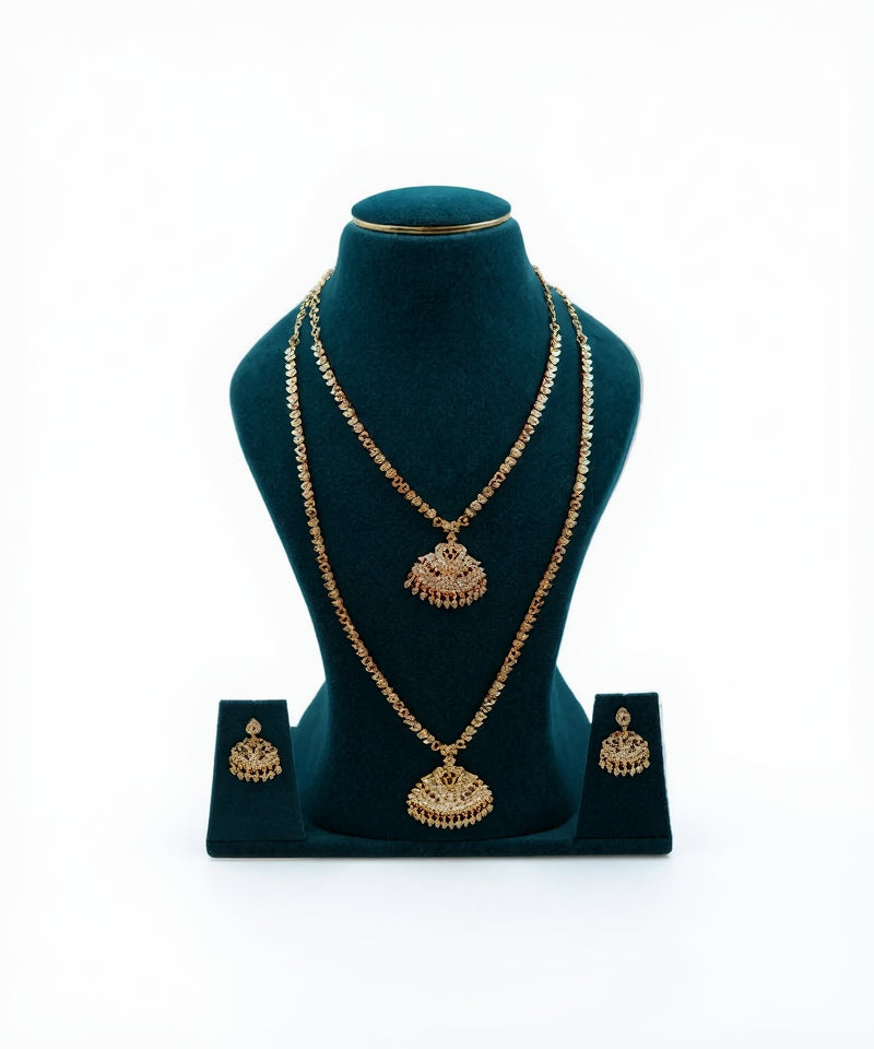 Lalithambike 1-gram gold jewelry combo set featuring a traditional choker, long haram necklace with fan-shaped pendants, and matching earrings on a teal display.