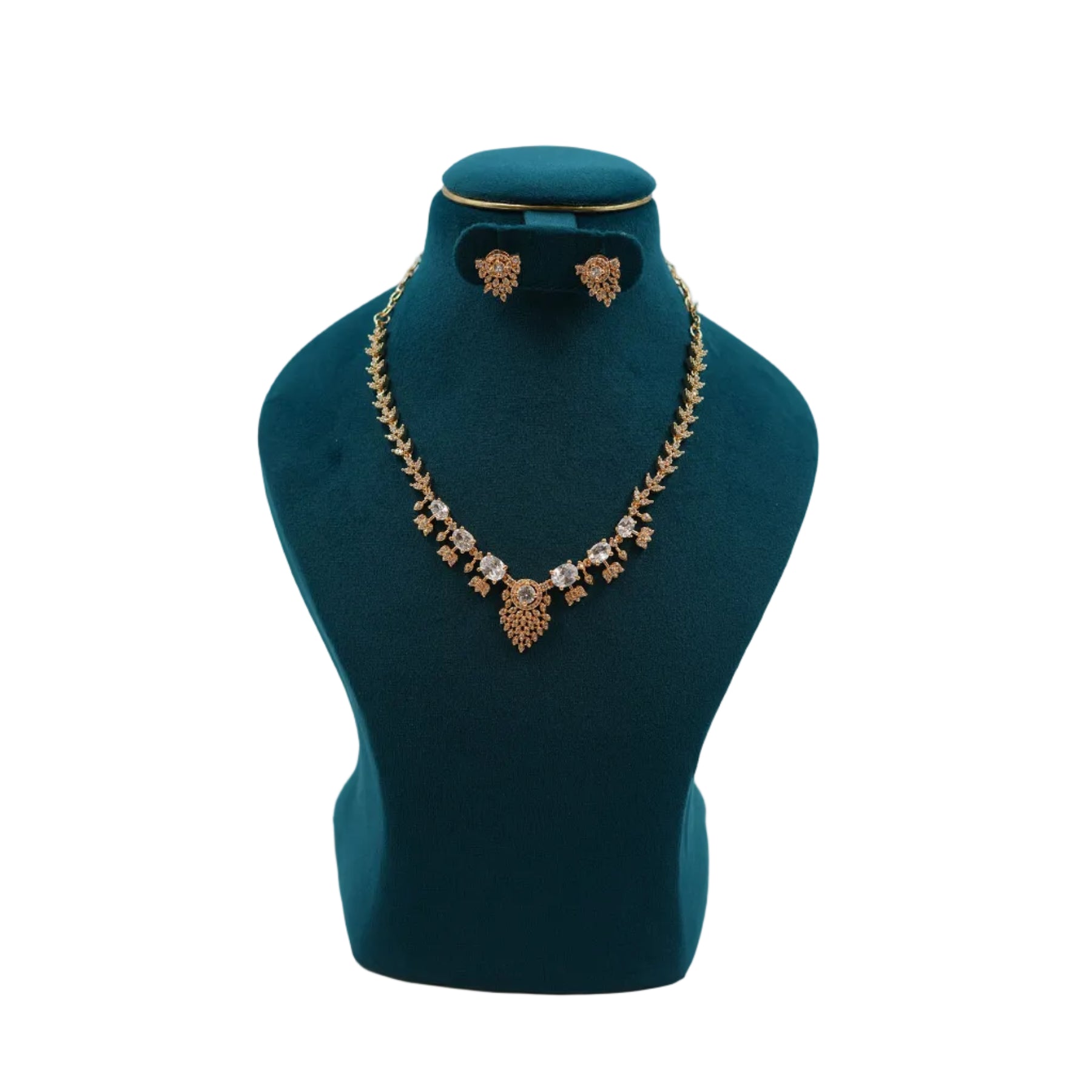Lalithambike 1-gram gold filigree necklace featuring brilliant clear crystals and a central floral drop pendant with matching earrings on a teal jewelry bust.