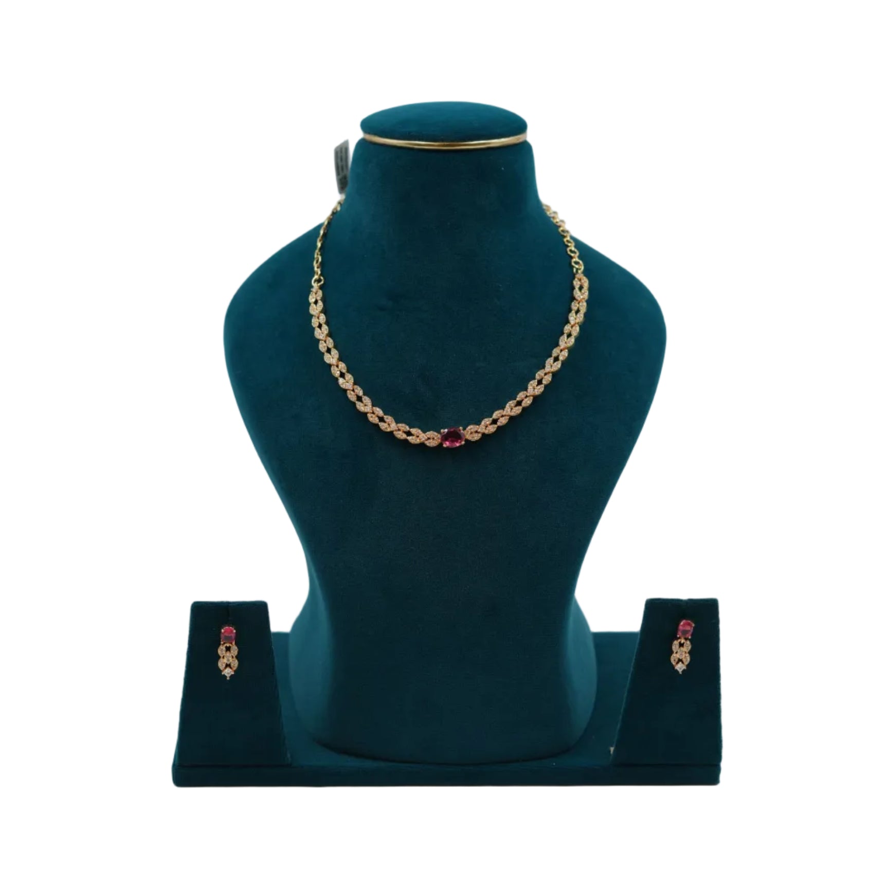 Lalithambike delicate 1-gram gold necklace featuring a leaf-motif chain and an oval ruby-toned center stone, with matching drop earrings on a teal jewelry bust.