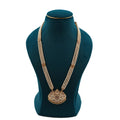 Lalithambike three-strand pearl long haram necklace featuring a large, intricate 1-gram gold-plated pendant with ruby accents on a teal jewelry bust.